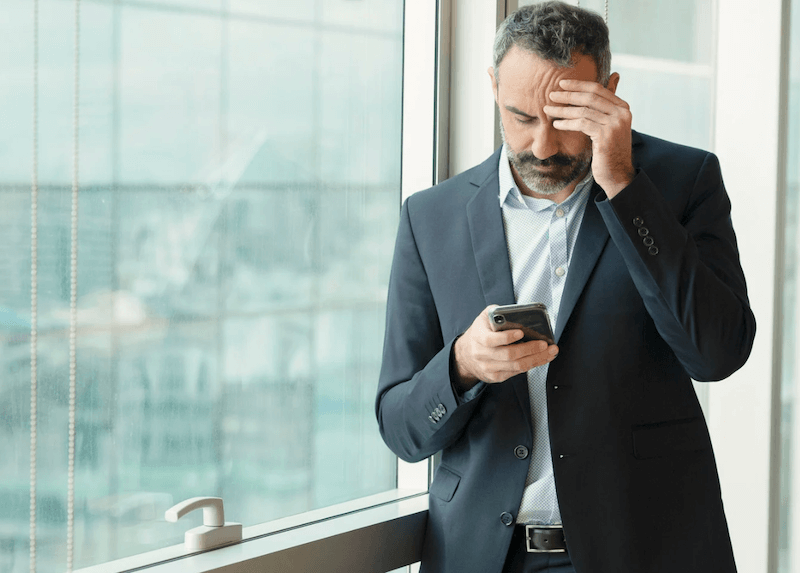 Professional man looking worried at phone