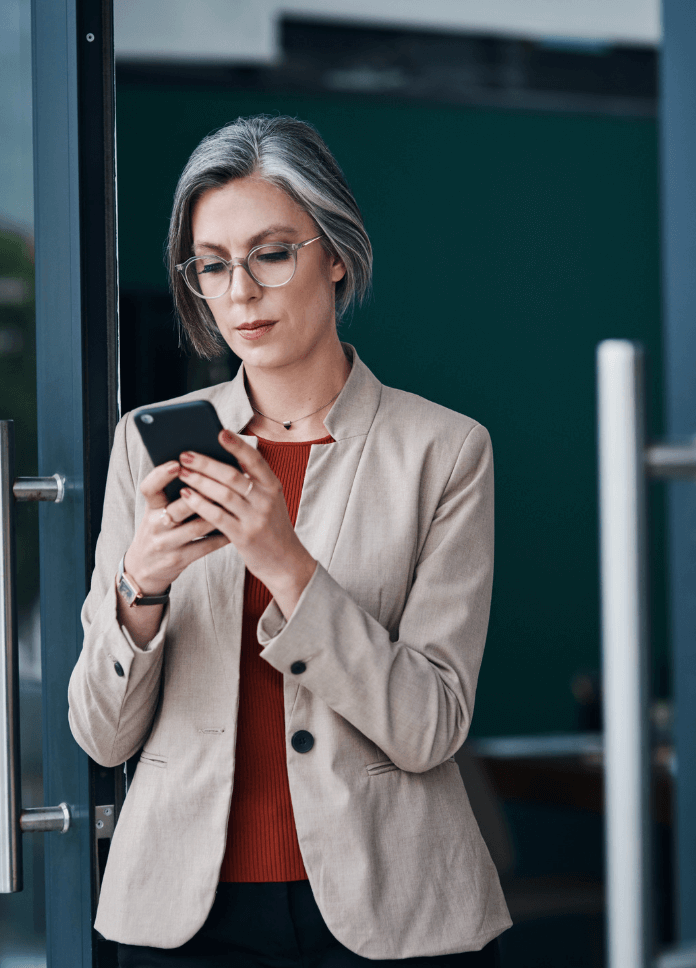 Professional looking woman reading her phone