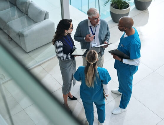 Five people around table having business meeting