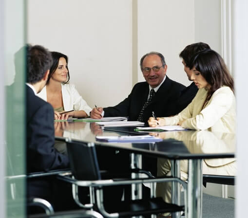 Five people around table having business meeting