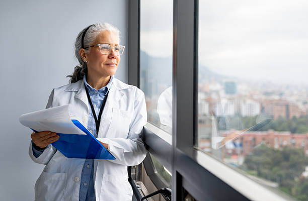 Female doctor gazing out of window