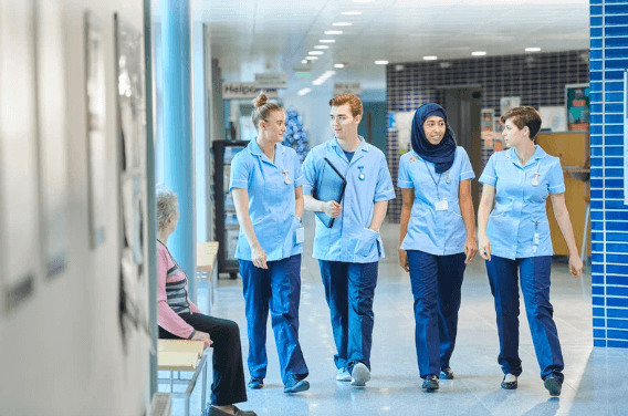 Group of nurses walking and chatting in a hospital