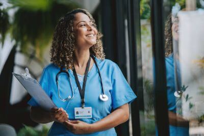 Nurse smiling and looking hopeful